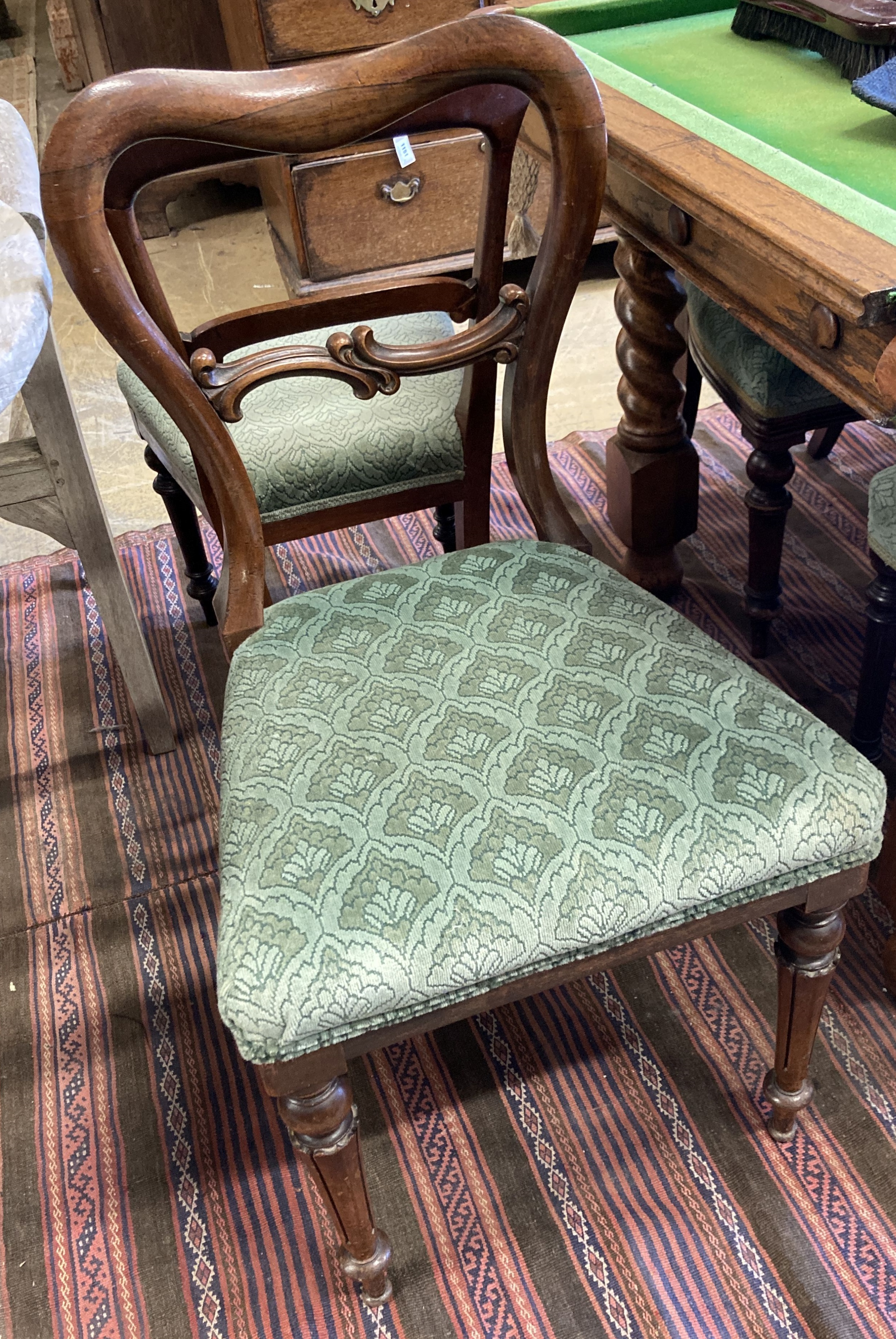 A harlequin set of eleven mahogany and rosewood balloon back dining chairs